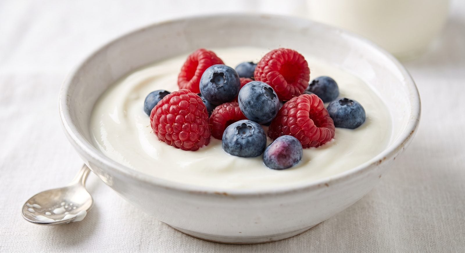 Yogurt with fresh raspberries and blueberries